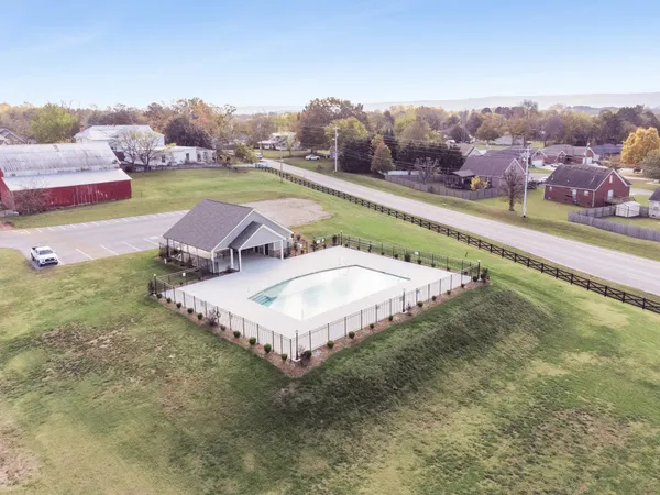 a view of a house with a yard and a pond