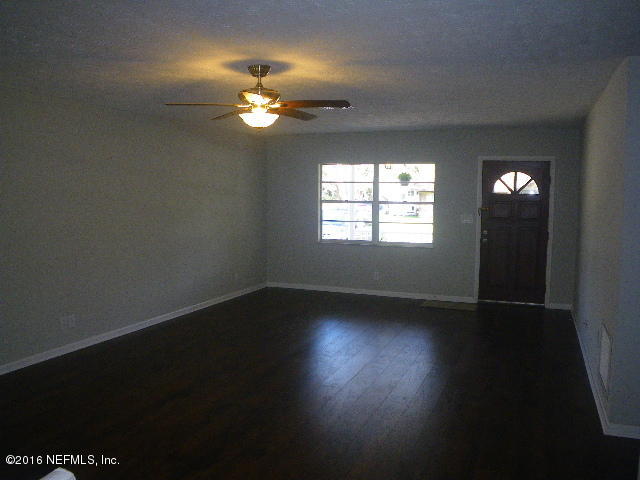 402 Jasmine Road St. Augustine, FL 32086 - Photo 20 of 33 a view of an empty room with wooden floor and a window