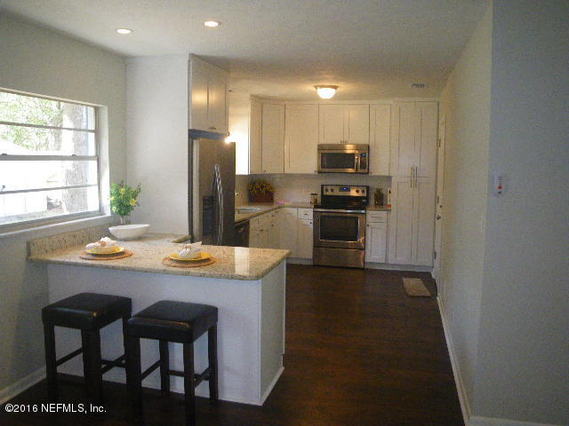 402 Jasmine Road St. Augustine, FL 32086 - Photo 2 of 33 a kitchen with kitchen island a sink stove and refrigerator