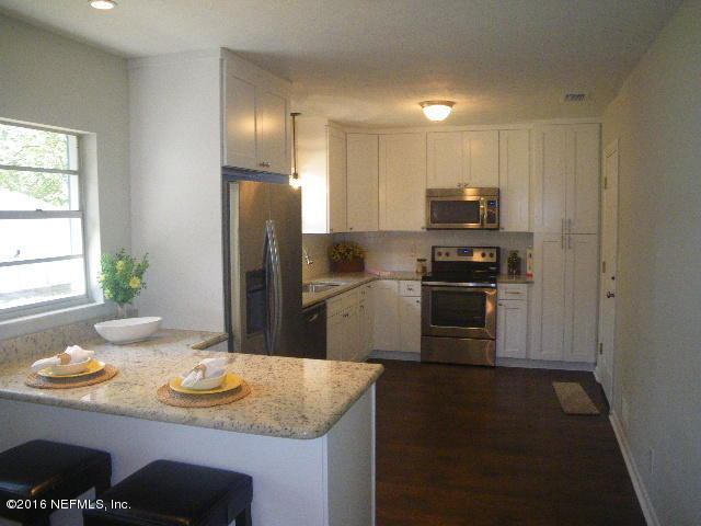 402 Jasmine Road St. Augustine, FL 32086 - Photo 4 of 33 a kitchen with stainless steel appliances granite countertop a sink a stove a refrigerator a washer dryer and dining table