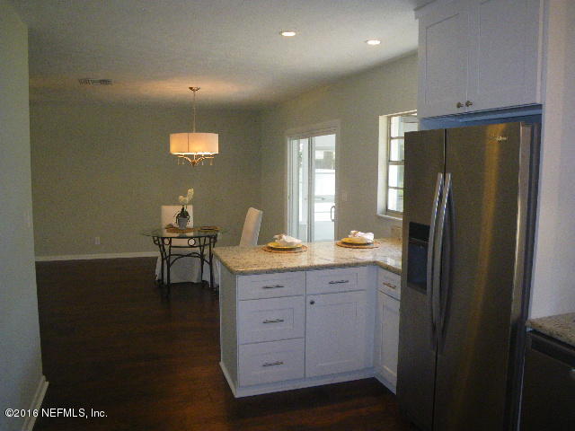 402 Jasmine Road St. Augustine, FL 32086 - Photo 5 of 33 a kitchen with a refrigerator and table in it