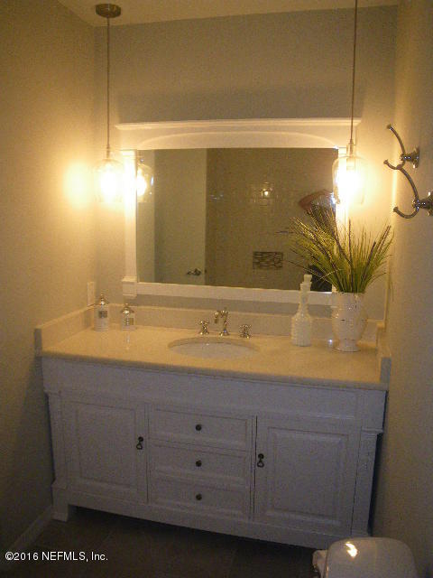 402 Jasmine Road St. Augustine, FL 32086 - Photo 7 of 33 a bathroom with a granite countertop sink and a mirror