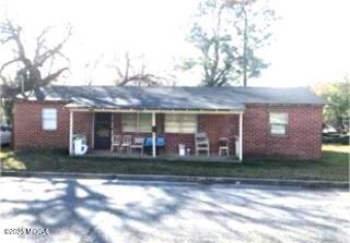 1144 Carroll Street Macon, GA 31206 - Photo 1 of 1 a front view of a house with a yard and potted plants