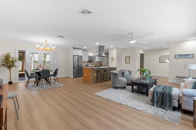 a kitchen with stainless steel appliances kitchen island granite countertop a refrigerator a stove and a sink