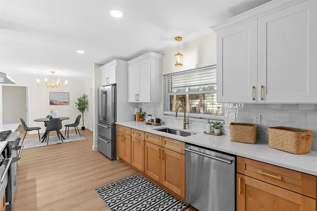 a view of a dining room with furniture and a chandelier
