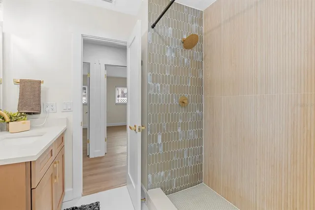 en empty room with windows and chandelier