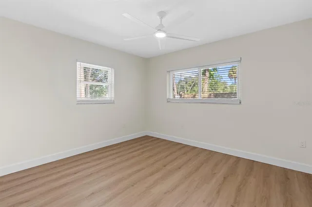 a view of a big room with windows and entryway of the house
