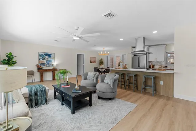 a living room with furniture a large window and a rug