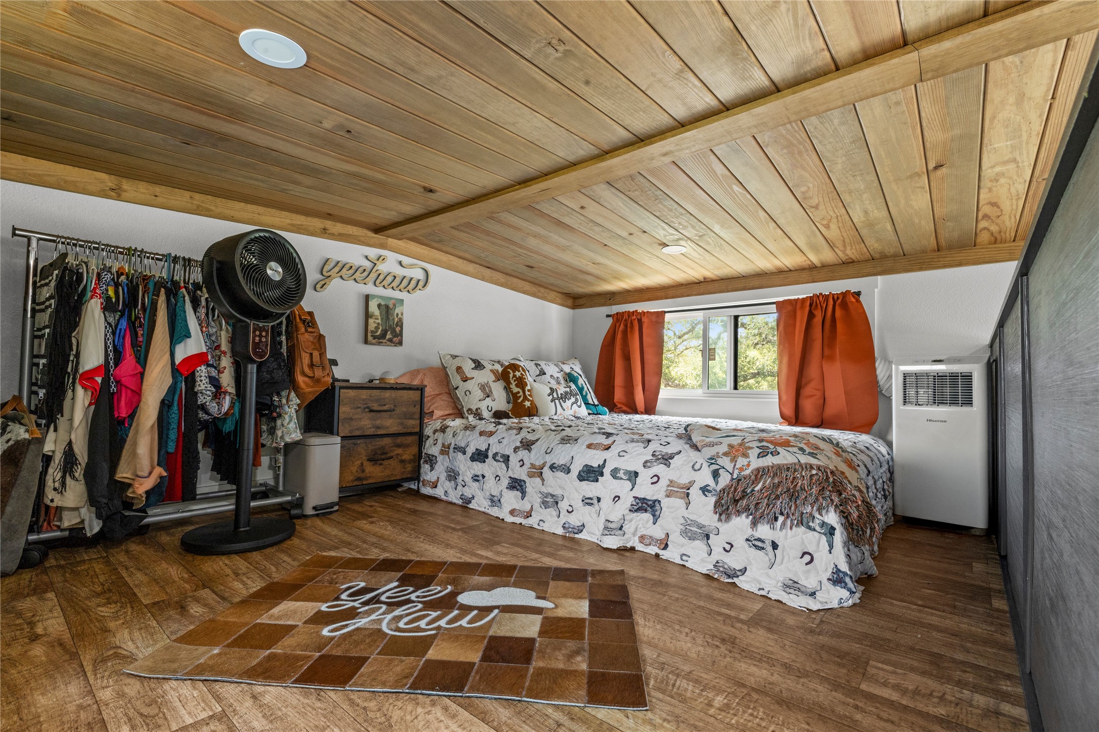 8200 Ranch Road 12 San Marcos, TX 78666 - Photo 18 of 40 Step into a cozy bedroom featuring wood planked ceilings and durable wood-look flooring.