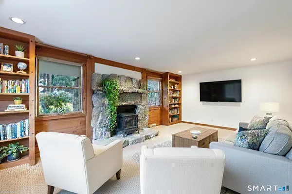 a living room with furniture large window and flat screen tv