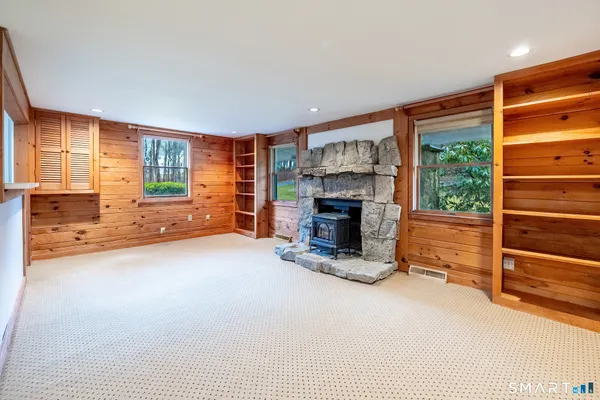 an empty room with furniture and a fireplace