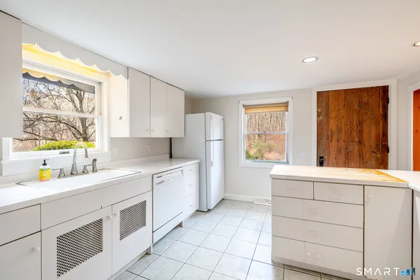 a kitchen with a sink cabinets and window
