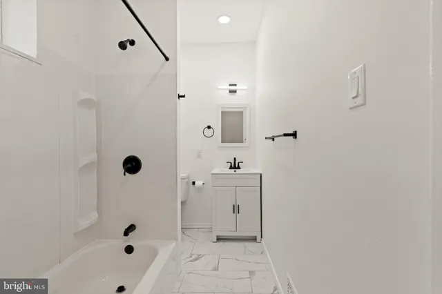 a bathroom with a bathtub and shower