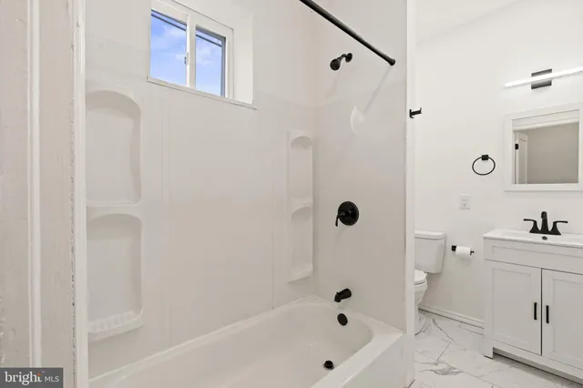 a bathroom with a bathtub a shower a sink and a mirror