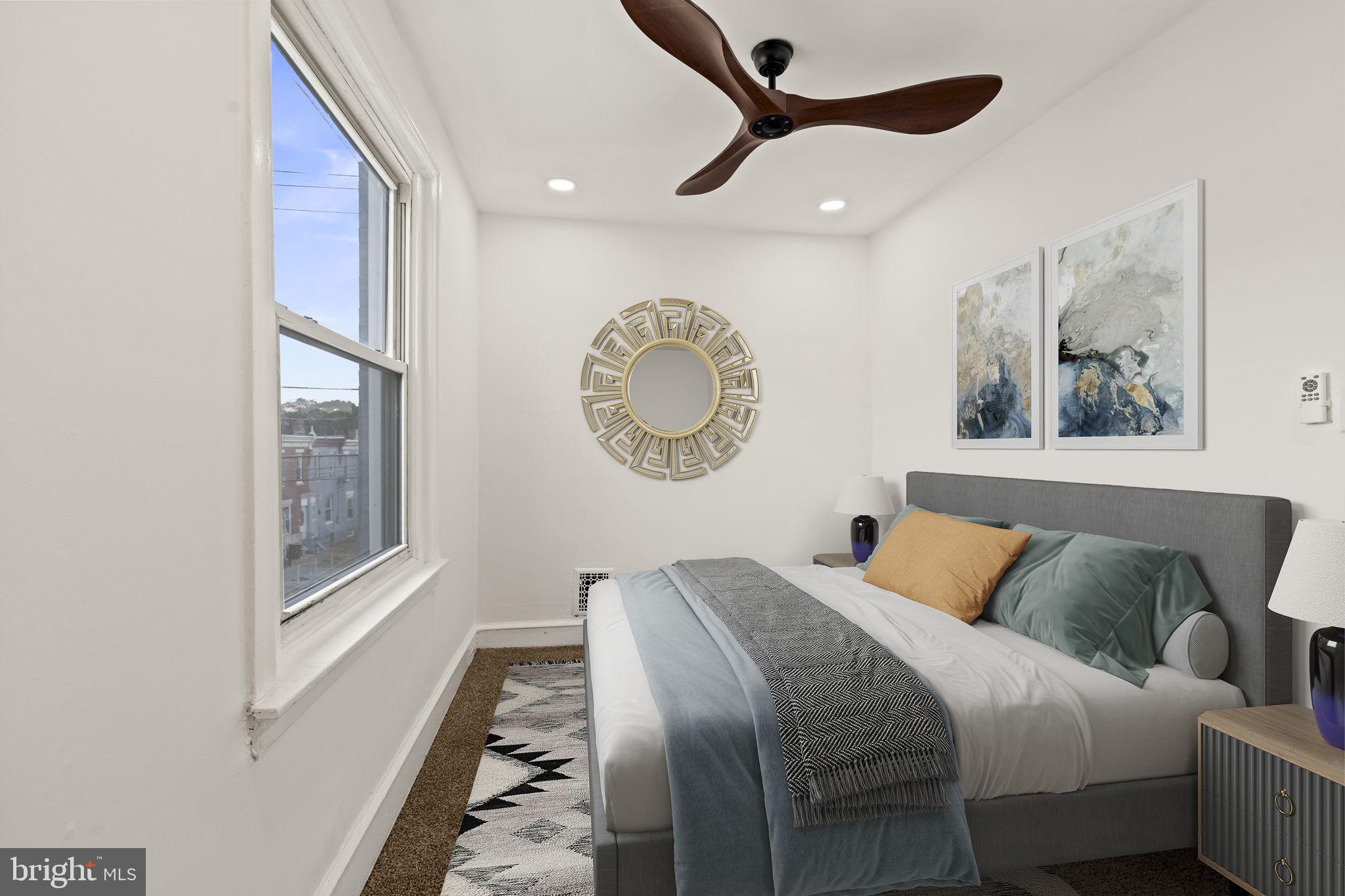 4466 North 3rd Street Philadelphia, PA 19140 - Photo 17 of 28 a bedroom with a large bed and a chandelier