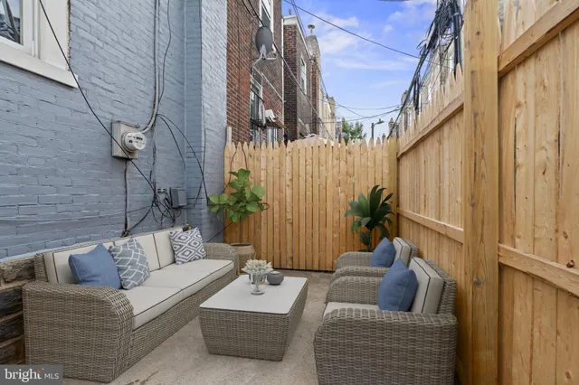 a view of a patio with couches and a potted plant