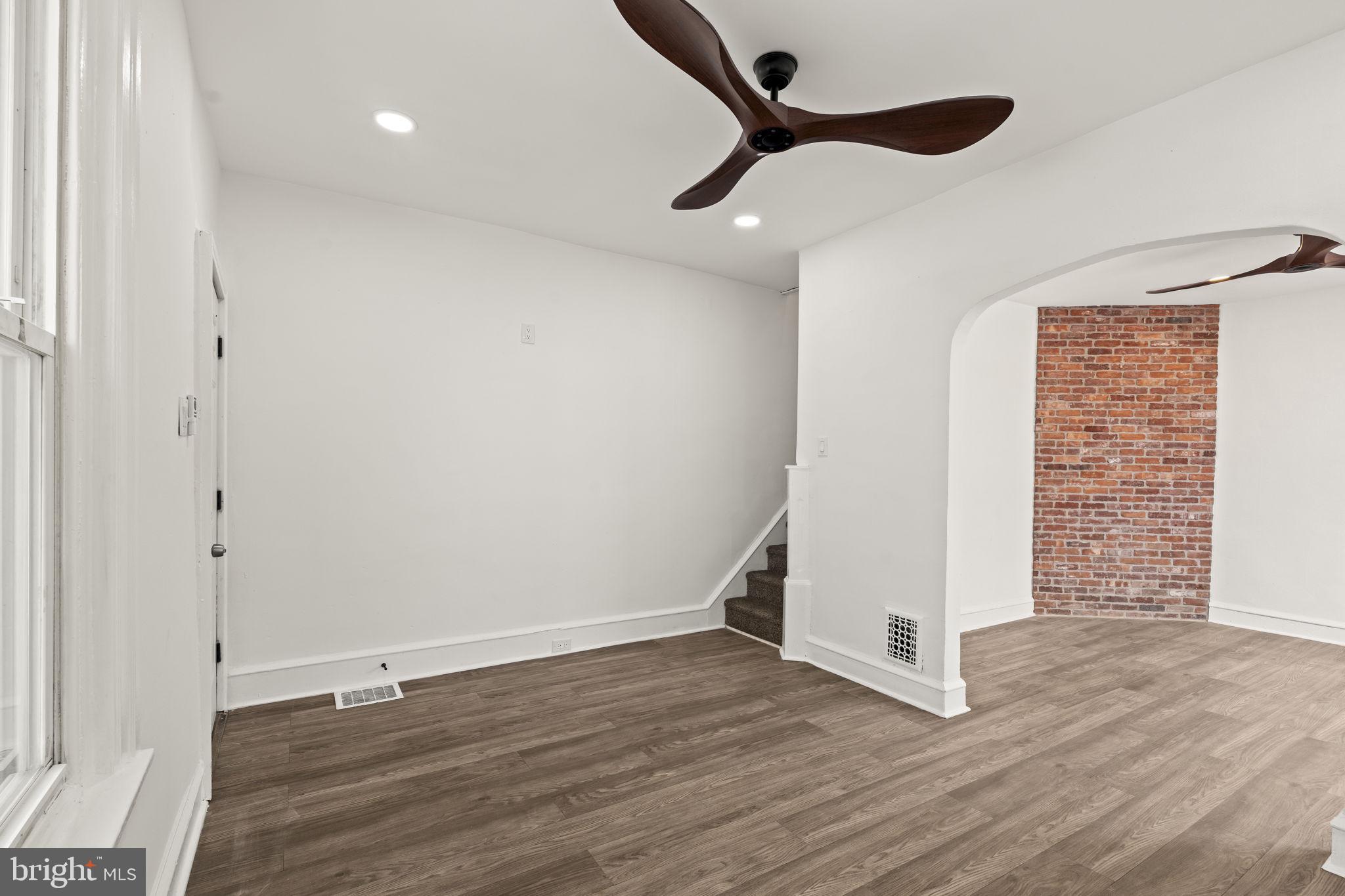 4466 North 3rd Street Philadelphia, PA 19140 - Photo 7 of 28 an empty room with wooden floor cabinet and windows