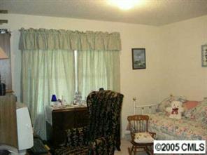 916 Stevens Road Monroe, NC 28110 - Photo 8 of 8 a bed room with a bed and a chair
