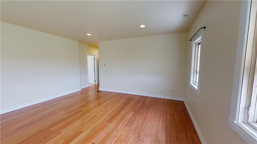 124 Welter Road Butler, PA 16002 - Photo 13 of 22 an empty room with wooden floor and windows