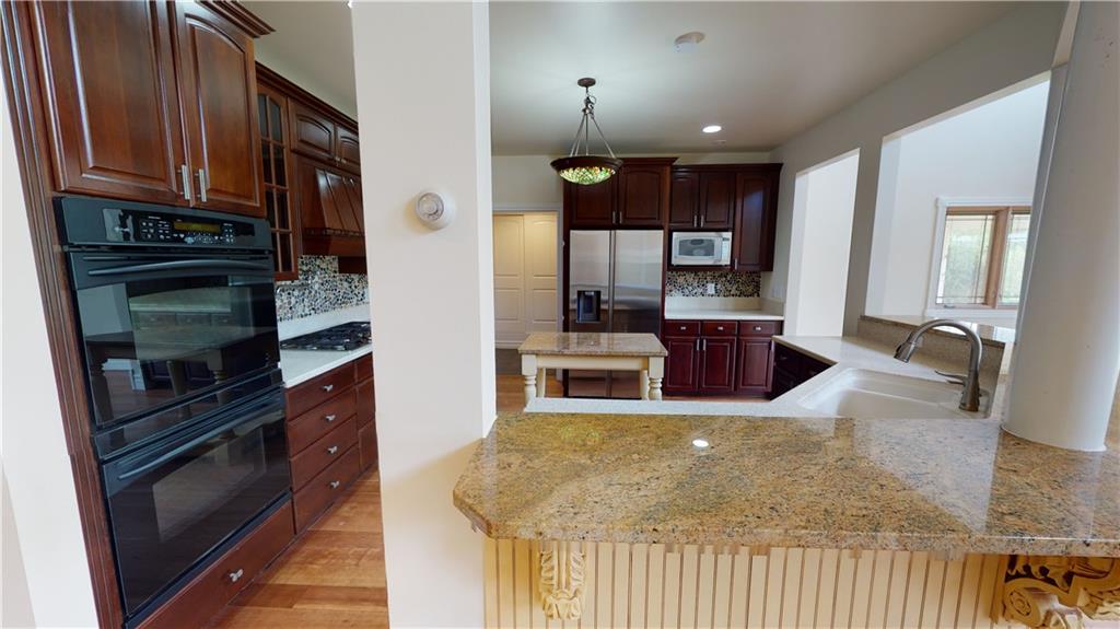 124 Welter Road Butler, PA 16002 - Photo 9 of 22 a kitchen with stainless steel appliances granite countertop a stove a refrigerator and a microwave