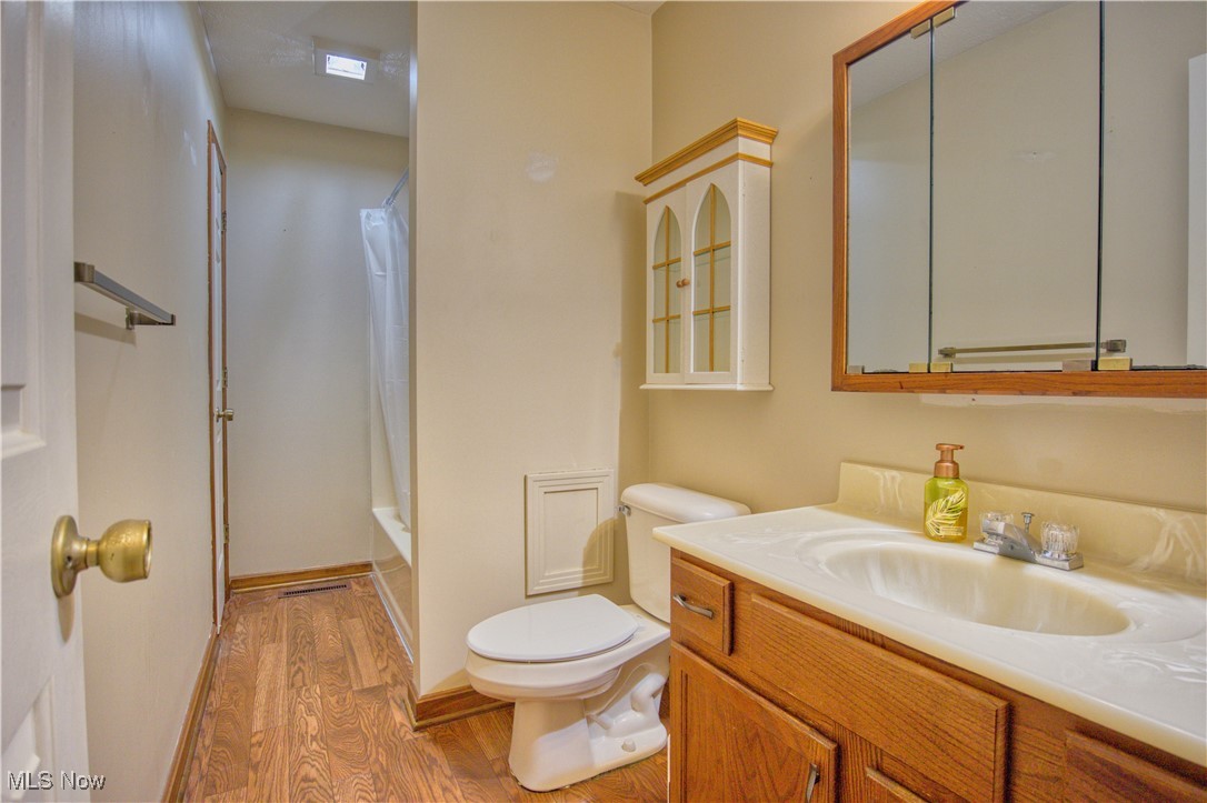 7017 Kirk Road Canfield, OH 44406 - Photo 34 of 35 Full bath featuring wood finished floors, vanity, and shower / tub combo