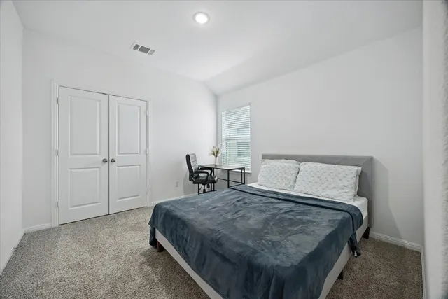 a bed room with a bed and chair