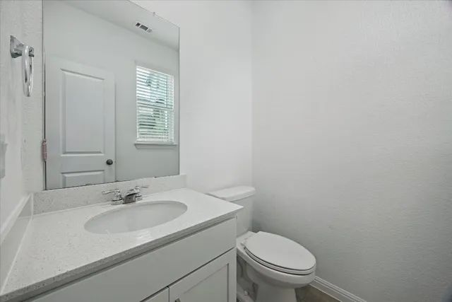 a bathroom with a sink toilet and a window
