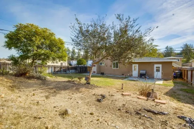 a view of a house with pool and sitting area