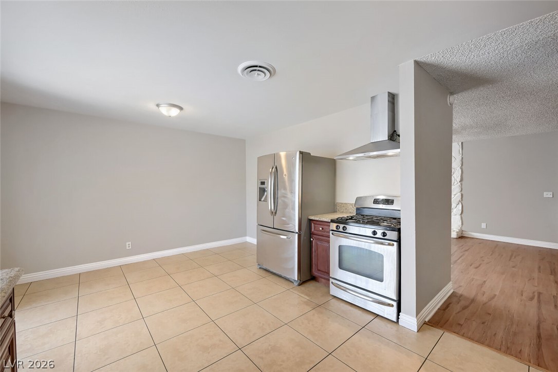 6321 Portola Road Las Vegas, NV 89108 - Photo 17 of 29 Culinary delights await in this modern kitchen with sleek stainless steel appliances and durable tile flooring.