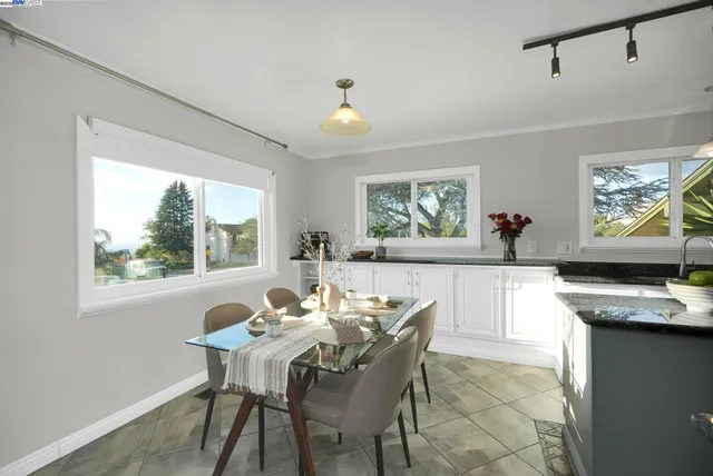 a kitchen with stainless steel appliances granite countertop a sink a stove and a refrigerator