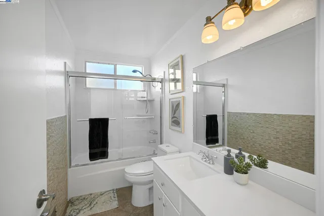 a spacious bathroom with a double vanity sink and a mirror