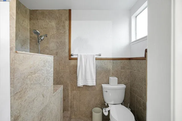 a living room with furniture and stairs