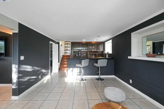 a view of a patio with table and chairs potted plants