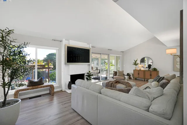 a living room with furniture a fireplace and a flat screen tv