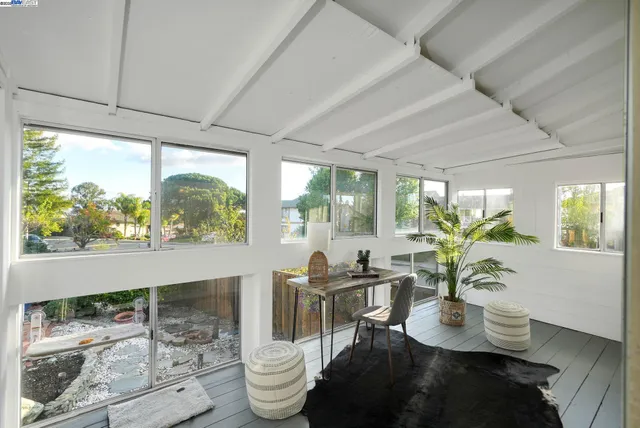 a view of a dining room with furniture a chandelier and wooden floor