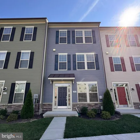 a front view of a house with yard and green space