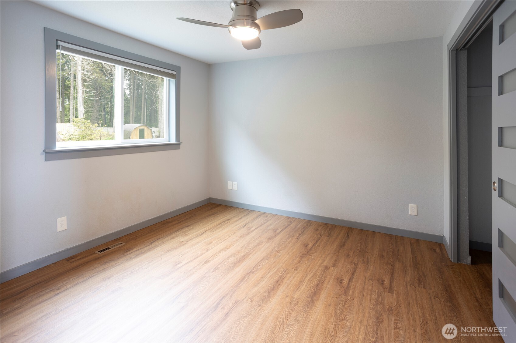 4631 Highway 109 Moclips, WA 98562 - Photo 19 of 35 an empty room with a window and wooden floor