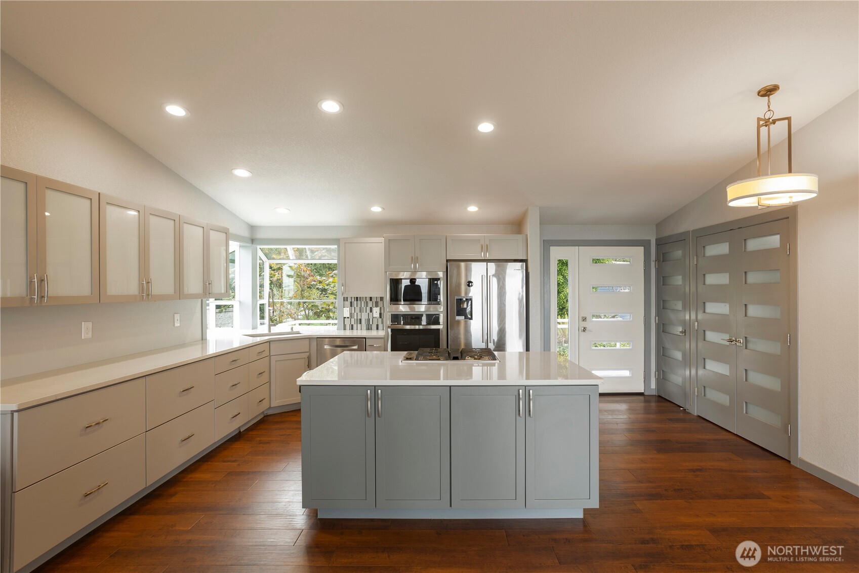 4631 Highway 109 Moclips, WA 98562 - Photo 7 of 35 a large kitchen with stainless steel appliances a large counter top a sink a refrigerator and a window