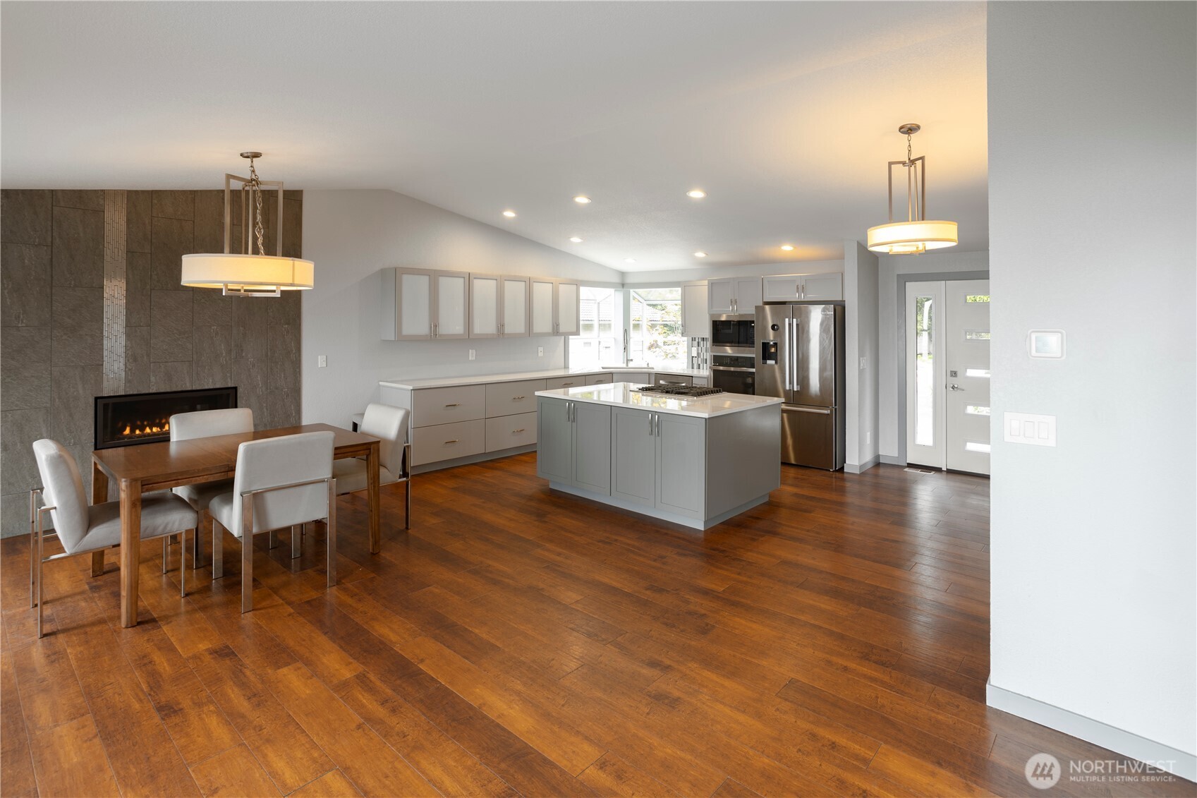 4631 Highway 109 Moclips, WA 98562 - Photo 9 of 35 a kitchen with a table chairs refrigerator and cabinets