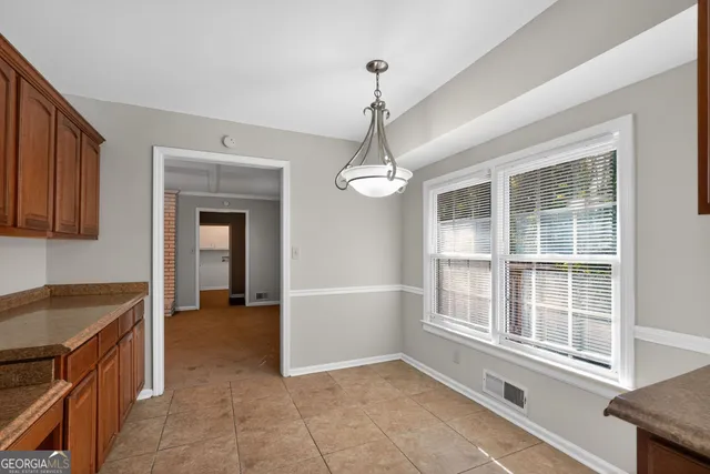 a view of a kitchen with a sink and dishwasher cabinet a fireplace