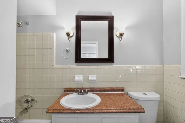 a bathroom with a sink a mirror and a toilet