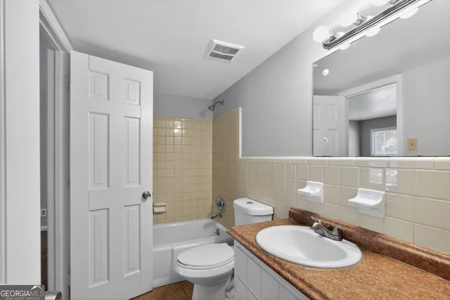 a bathroom with a sink toilet a mirror and shower