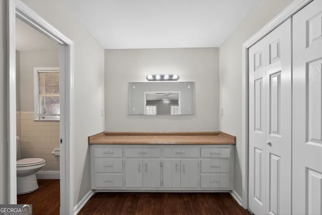 a bathroom with a toilet a sink a mirror and a bathtub