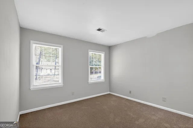 a view of an empty room with windows