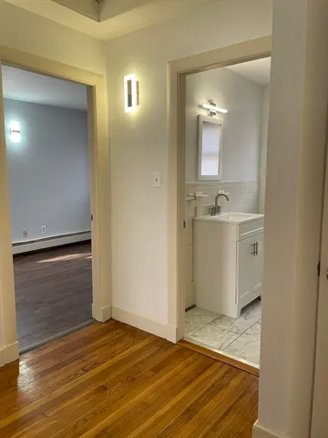 a bathroom with a sink a toilet and a mirror