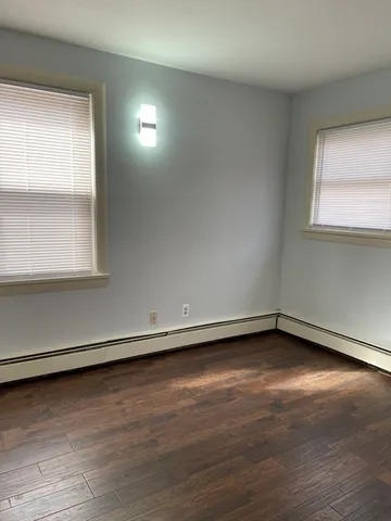 a view of a lake with a bench and trees