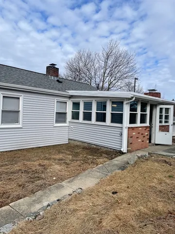 a view of a house with a backyard