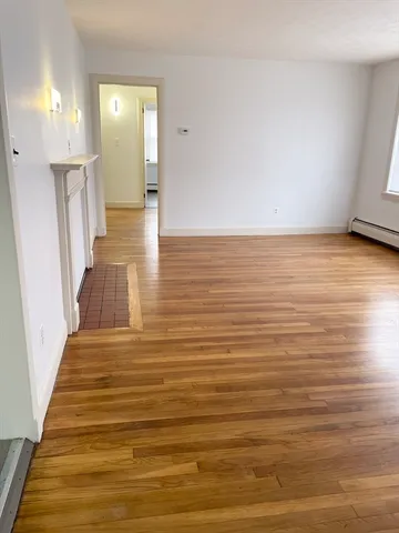 a view of a room with wooden floor