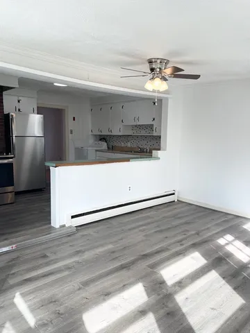 a view of a kitchen with a sink and wooden floor