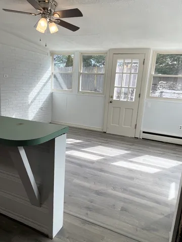 a view of a room with wooden floor and windows